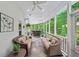 Relaxing screened porch with comfortable seating and a bar area for entertaining Gathering and friends at 162 Daltree Ct, Marietta, GA 30068