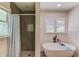 Modern bathroom featuring a soaking tub, walk-in shower, and natural light at 2020 Commonwealth Pl, Cumming, GA 30041