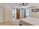 A cozy bedroom with a ceiling fan, sliding barn door to the ensuite, and a view to the deck at 2020 Commonwealth Pl, Cumming, GA 30041