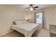 Bright bedroom featuring plush carpeting, a ceiling fan, and a large window at 2020 Commonwealth Pl, Cumming, GA 30041