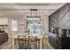 Bright dining area with stylish light fixture, access to the backyard, and a sleek sideboard for storage and serving at 2020 Commonwealth Pl, Cumming, GA 30041