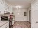 Charming kitchen with white cabinetry, wood floors, and modern appliances, creating an inviting space for cooking at 2020 Commonwealth Pl, Cumming, GA 30041