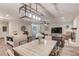 An open living and kitchen area featuring modern lighting, stainless appliances, and hardwood style flooring at 2020 Commonwealth Pl, Cumming, GA 30041