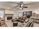 Spacious living room blends into a dining area with stainless appliances, hardwood floors, and a cozy fireplace at 2020 Commonwealth Pl, Cumming, GA 30041