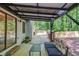 Covered outdoor patio featuring comfortable seating and extended deck at 2020 Commonwealth Pl, Cumming, GA 30041