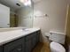 Bathroom featuring a large mirror, vanity, toilet, and shower at 2065 Sandgate Cir, Atlanta, GA 30349