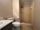 Bathroom featuring a tiled shower and neutral color palette at 2065 Sandgate Cir, Atlanta, GA 30349