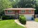 Charming split-level home with a well-manicured lawn and mature trees at 2065 Sandgate Cir, Atlanta, GA 30349