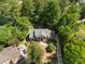 Aerial view of stately home nestled among mature trees, showcasing classic architecture and landscaping at 2595 Winthrope Way, Lawrenceville, GA 30044