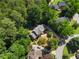 Bird's eye view of a gorgeous home, featuring verdant landscaping and a peaceful, tree-lined setting at 2595 Winthrope Way, Lawrenceville, GA 30044