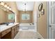 Bathroom features a soaking tub under a leaded glass window at 2595 Winthrope Way, Lawrenceville, GA 30044