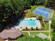 A luxurious community pool with tennis courts and playground equipment in a wooded area at 2595 Winthrope Way, Lawrenceville, GA 30044
