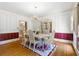 Formal dining room with hardwood floors, a decorative rug, and a classic chandelier above the table at 2595 Winthrope Way, Lawrenceville, GA 30044