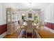 Formal dining area featuring a decorative china cabinet, chandelier, and windows for natural light at 2595 Winthrope Way, Lawrenceville, GA 30044