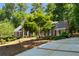 Traditional brick home complemented by a spacious driveway lined with manicured landscaping at 2595 Winthrope Way, Lawrenceville, GA 30044