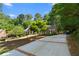 Traditional home featuring a spacious driveway enhanced by meticulously maintained landscaping at 2595 Winthrope Way, Lawrenceville, GA 30044