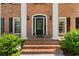 Inviting brick home showcasing a decorative front door, sidelights, and manicured landscaping at 2595 Winthrope Way, Lawrenceville, GA 30044