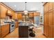 Bright kitchen featuring stainless steel appliances, a granite island, and hardwood floors at 2595 Winthrope Way, Lawrenceville, GA 30044