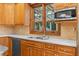 Kitchen area with stainless steel dishwasher and sink under a bright window at 2595 Winthrope Way, Lawrenceville, GA 30044