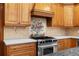 Cozy kitchen with stainless steel oven range, gas stovetop, and custom tile backsplash at 2595 Winthrope Way, Lawrenceville, GA 30044