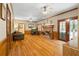 Inviting living room with hardwood floors, wood paneling, and a brick fireplace at 2595 Winthrope Way, Lawrenceville, GA 30044