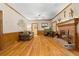 Cozy living room featuring hardwood floors, a brick fireplace, and natural light at 2595 Winthrope Way, Lawrenceville, GA 30044