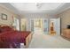 Bright main bedroom with tray ceilings, carpet, and an en-suite bathroom at 2595 Winthrope Way, Lawrenceville, GA 30044