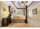 Spacious bedroom with a four-poster bed, tray ceiling, and abundant natural light at 2595 Winthrope Way, Lawrenceville, GA 30044