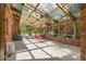 Bright sunroom with glass roof, brick walls, and tile floors offers a unique, airy living space at 2595 Winthrope Way, Lawrenceville, GA 30044