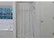 This bright bathroom has a tiled tub and a window with a lovely nature view at 402 Wood Chase Ln, Canton, GA 30114