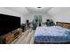 Bedroom with vaulted ceilings and wood-look floors features a large screen TV at 402 Wood Chase Ln, Canton, GA 30114