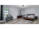 Spacious bedroom with ample natural light, wood-look floors, and neutral decor at 402 Wood Chase Ln, Canton, GA 30114