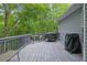 Enjoy the wooded views from this spacious deck, perfect for outdoor dining with table, chairs and grill at 402 Wood Chase Ln, Canton, GA 30114