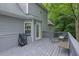 Relax on the deck of this home, featuring a seating area and grill, perfect for enjoying the wooded scenery at 402 Wood Chase Ln, Canton, GA 30114