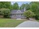 Charming home featuring a classic covered front porch and well-maintained landscaping at 402 Wood Chase Ln, Canton, GA 30114