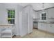 Well-lit kitchen featuring white cabinets and stainless steel dishwasher and range at 402 Wood Chase Ln, Canton, GA 30114