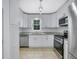 Bright kitchen showcasing stainless steel appliances and white cabinets with granite counters at 402 Wood Chase Ln, Canton, GA 30114