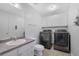Convenient laundry area with modern appliances, sink, and built-in storage at 402 Wood Chase Ln, Canton, GA 30114