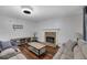 Spacious living room featuring hard wood floors, a fireplace, and ample natural light at 402 Wood Chase Ln, Canton, GA 30114