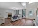 Inviting living room with a cozy fireplace, wood floors, and ample natural light at 402 Wood Chase Ln, Canton, GA 30114