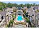 Stunning aerial view of a community pool surrounded by upscale townhomes and lush landscaping at 6635 Beacon Dr, Atlanta, GA 30328