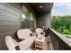 Cozy balcony with wicker furniture and grill, perfect for outdoor relaxation at 6635 Beacon Dr, Atlanta, GA 30328