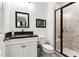Modern bathroom features black hardware, white marble tile shower, and sleek vanity at 6635 Beacon Dr, Atlanta, GA 30328