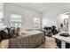 Cozy bedroom with neutral decor, lots of pillows, and natural light from multiple windows at 6635 Beacon Dr, Atlanta, GA 30328