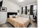 Comfortable bedroom with neutral carpet, stylish decor, and dual windows at 6635 Beacon Dr, Atlanta, GA 30328
