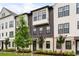 Attractive townhouse exterior features a mix of white and gray materials with complementary black framed windows at 6635 Beacon Dr, Atlanta, GA 30328