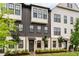 Attractive townhouse exterior with a mix of white brick and dark wood accents offers modern charm at 6635 Beacon Dr, Atlanta, GA 30328