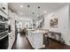 Bright kitchen boasts stainless appliances, pendant lighting over the island, and dark hardwood floors at 6635 Beacon Dr, Atlanta, GA 30328