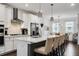 Modern kitchen featuring white cabinets, stainless steel appliances, and a stylish island with barstool seating at 6635 Beacon Dr, Atlanta, GA 30328