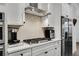 Gourmet kitchen with stainless steel appliances, gas cooktop and vent hood, and sleek cabinetry at 6635 Beacon Dr, Atlanta, GA 30328
